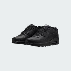 Angled view of two Nike Air Max 90 Juniors' black trainers, side by side, showcasing their timeless aesthetic and clean, dark colourway.