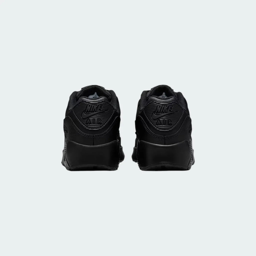 Rear view of the Nike Air Max 90 Juniors' black trainers, focusing on the prominent Nike Air branding on the heel tab.