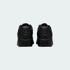 Rear view of the Nike Air Max 90 Juniors' black trainers, focusing on the prominent Nike Air branding on the heel tab.