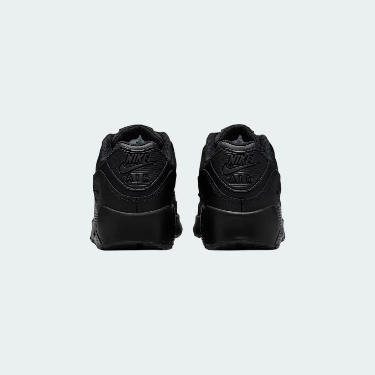 Rear view of the Nike Air Max 90 Juniors' black trainers, focusing on the prominent Nike Air branding on the heel tab.