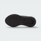 Displays the full-length black rubber sole, showcasing the multi-directional lug grid pattern engineered for unreal grip on outdoor play surfaces and indoor court floors.
