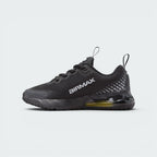 Displays the inner profile of the shoe, featuring white "AIRMAX" block lettering stamped across the black mesh upper set against the gradient dotted heel accents and yellow-tinted heel Air unit.