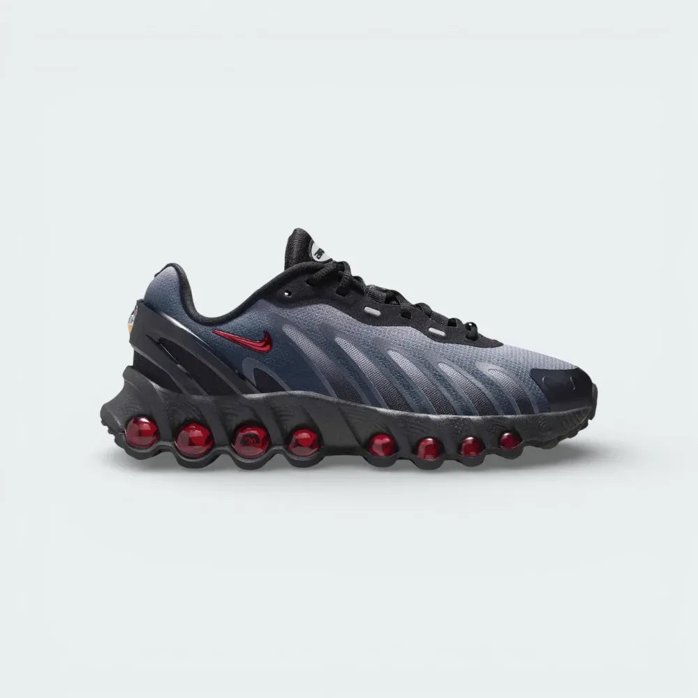 Side profile of the Nike Air Max DN8 Juniors' trainers in black mesh, showing the Gym Red Max Air units and the Light Smoke Grey midsole detailing.