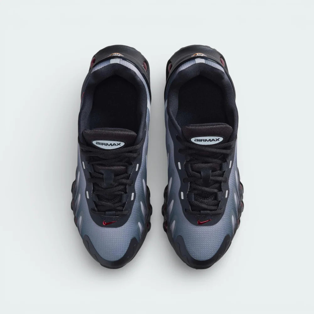 Top-down view of the black and red Air Max DN8 trainers, highlighting the haptic mesh texture and the Gym Red DN logo on the tongue.