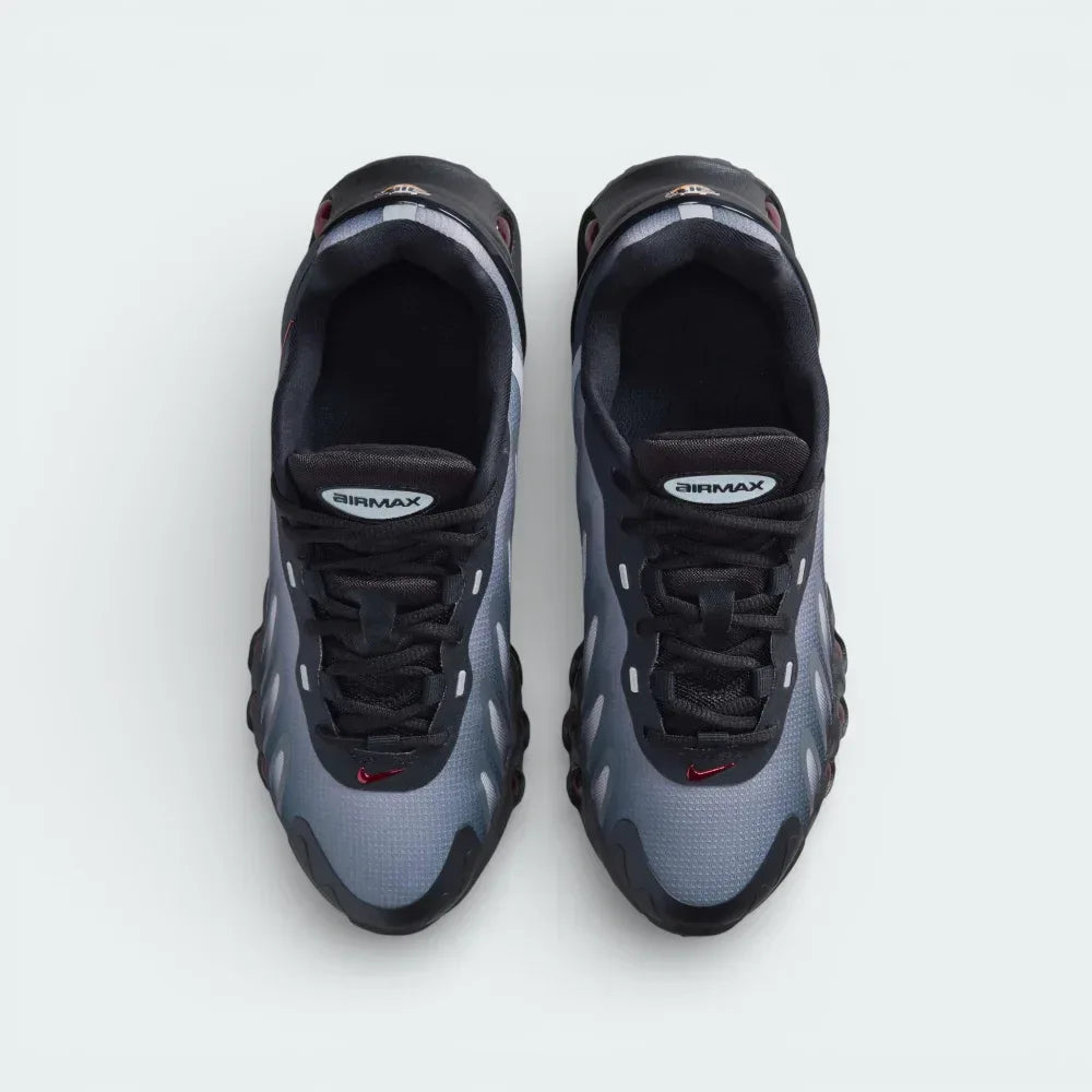 Top-down view of the black and red Air Max DN8 trainers, highlighting the haptic mesh texture and the Gym Red DN logo on the tongue.