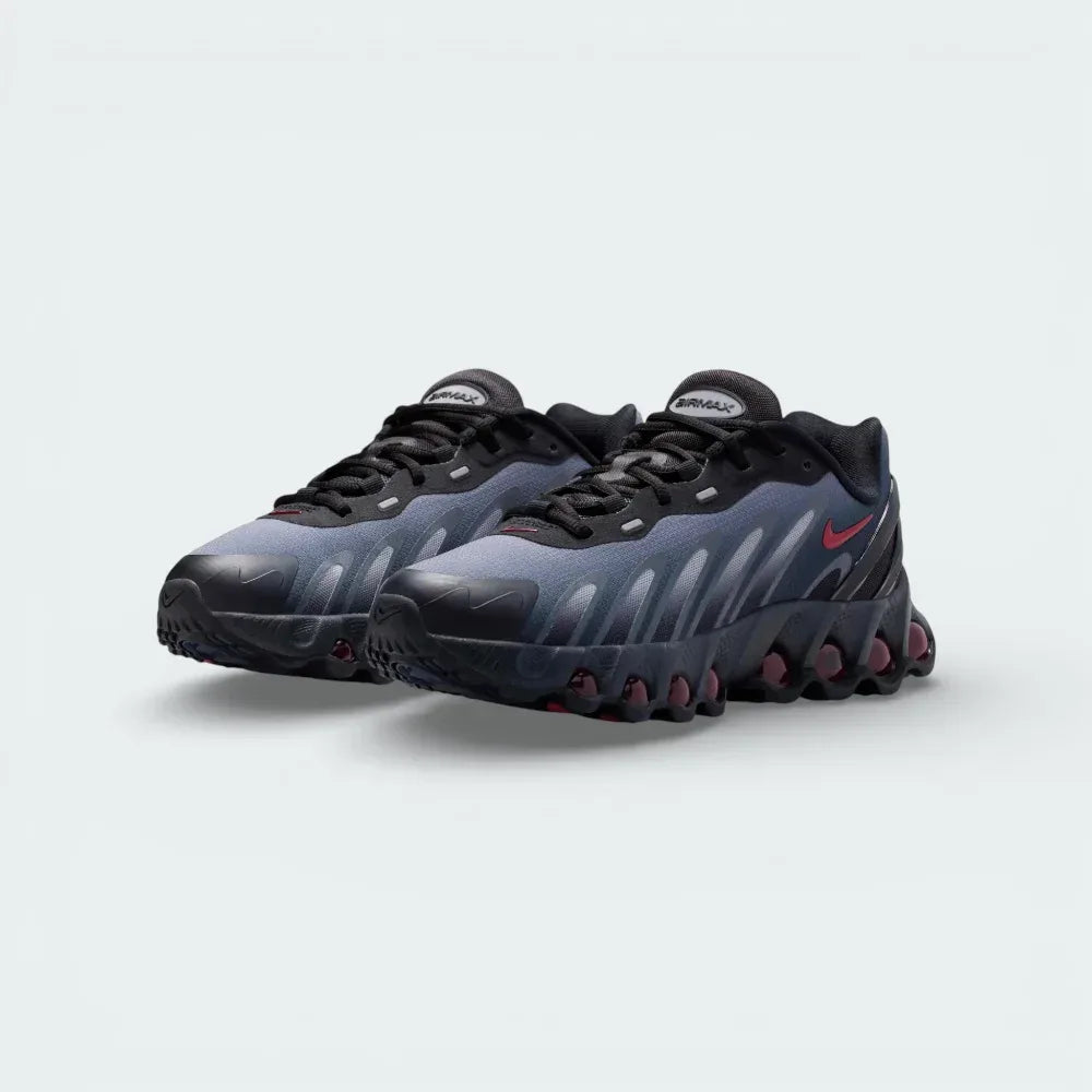Angled shot of both Nike DN8 trainers side by side, showcasing the aerodynamic shape and the bold contrast between the black mesh and red accents.