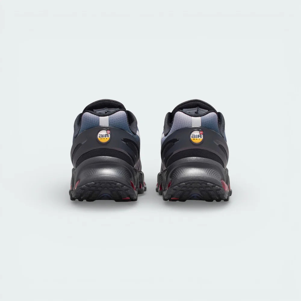 Rear view focusing on the stacked multi-chamber Air units in Gym Red and the structured heel clip featuring the circular DN emblem.