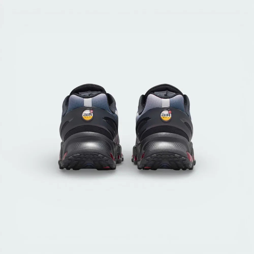 Rear view focusing on the stacked multi-chamber Air units in Gym Red and the structured heel clip featuring the circular DN emblem.