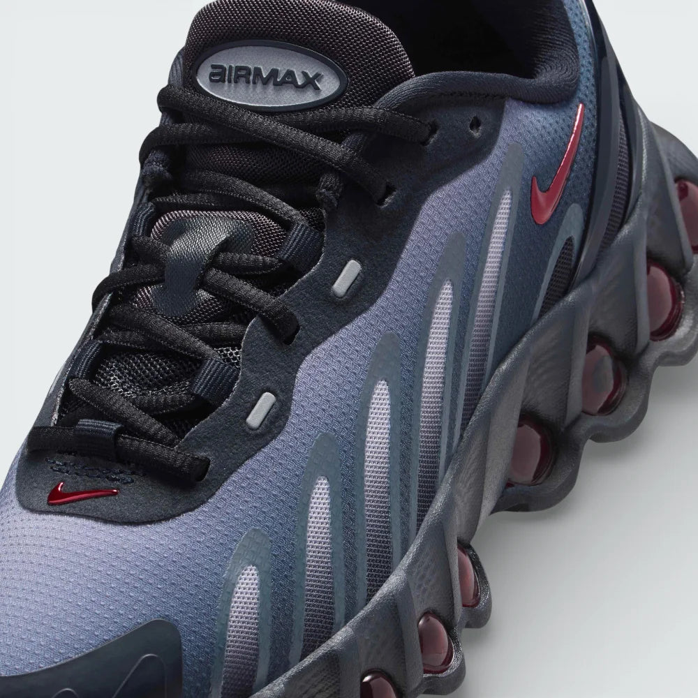 Close-up of the front, showing the detailed haptic mesh upper and the secure black lacing system for a locked-in fit.