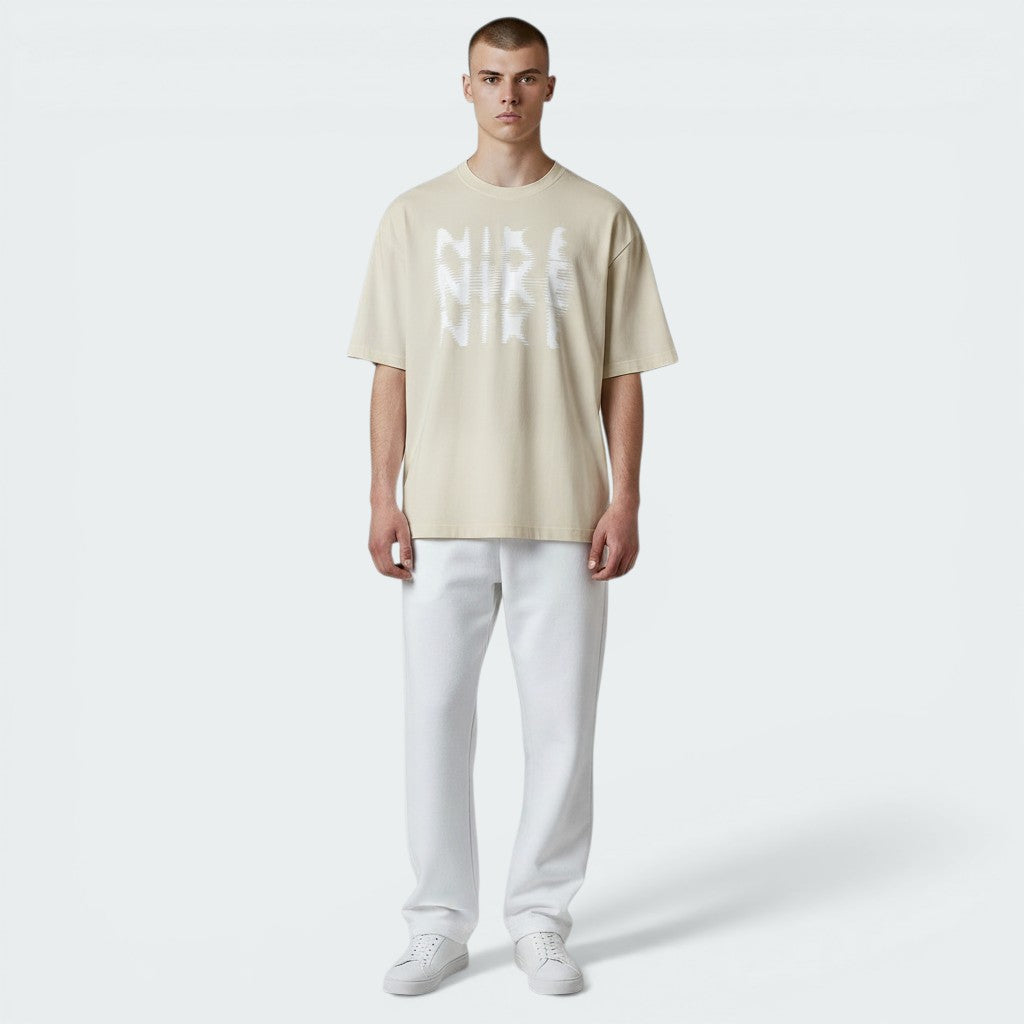 The Beige Hyverse tee, highlighting the athletic sleeve cut and the lightweight drape of the Dri-FIT fabric.