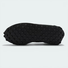 View of the black rubber Waffle outsole, showcasing the deep lugs and the extra-wide footprint of the flared heel.