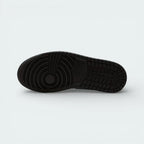 View of the solid rubber outsole, showcasing the iconic Jordan 1 traction pattern and pivot circle in a tonal white finish.