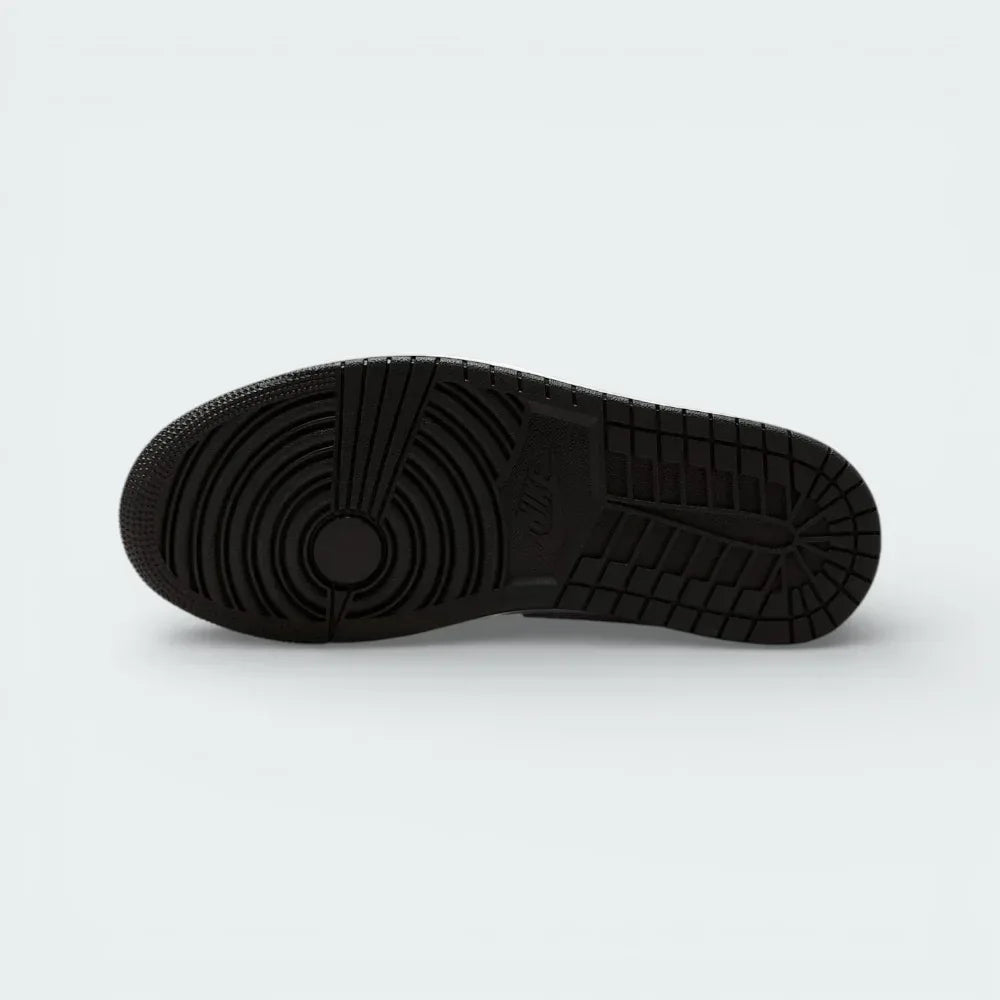 View of the solid rubber outsole, showcasing the iconic Jordan 1 traction pattern and pivot circle in a tonal white finish.
