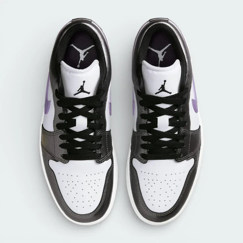 Top-down view of the trainers, highlighting the perforated toe box and the crisp white lacing system against the premium leather tongue.