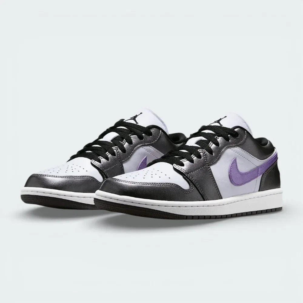 Angled shot of both Air Jordan 1 Low SE trainers, showcasing the luxurious material mix and the sleek, low-profile silhouette.
