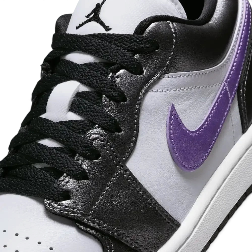 Close-up of the front, showing the quality of the white leather grain and the precision stitching around the toe cap.