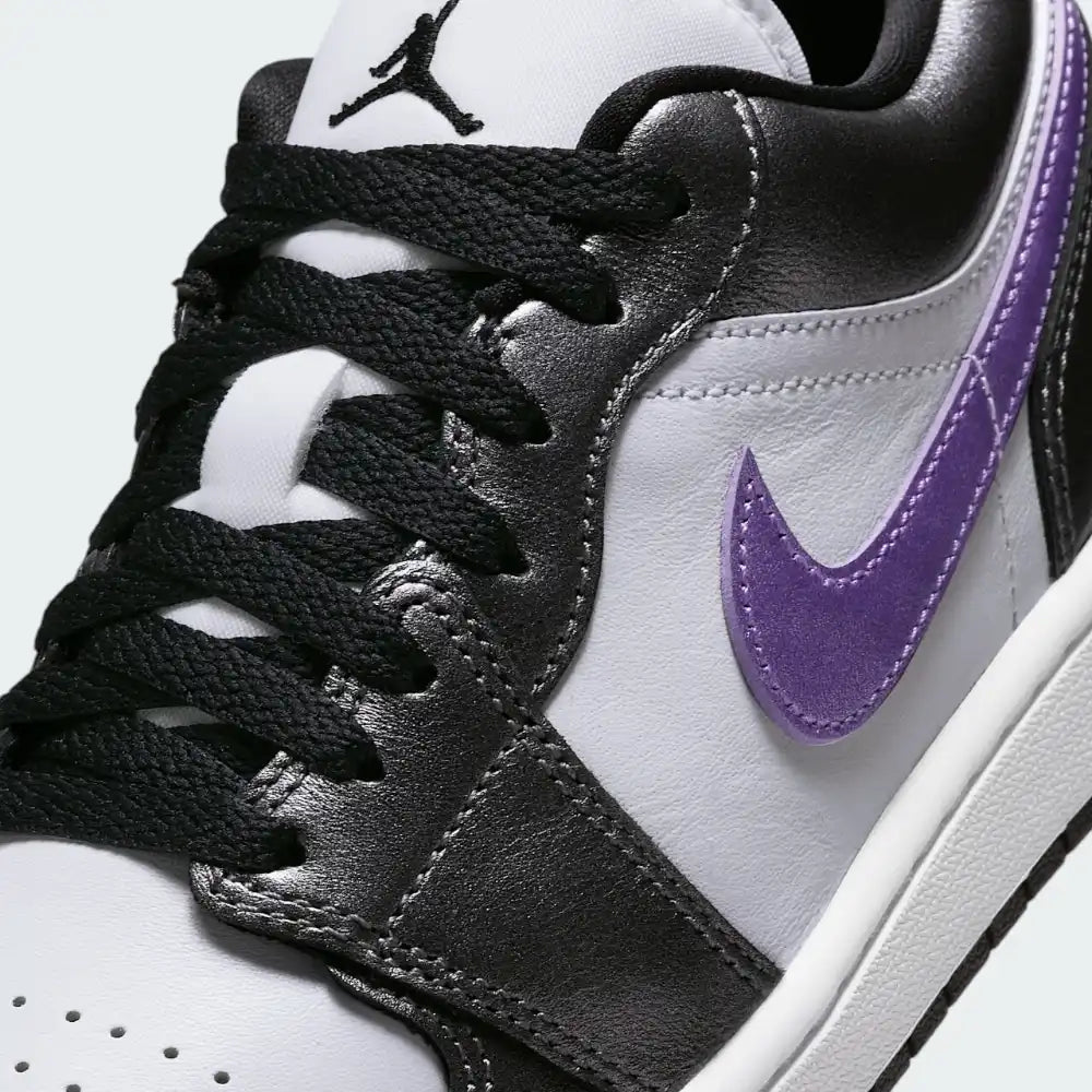 Close-up of the front, showing the quality of the white leather grain and the precision stitching around the toe cap.