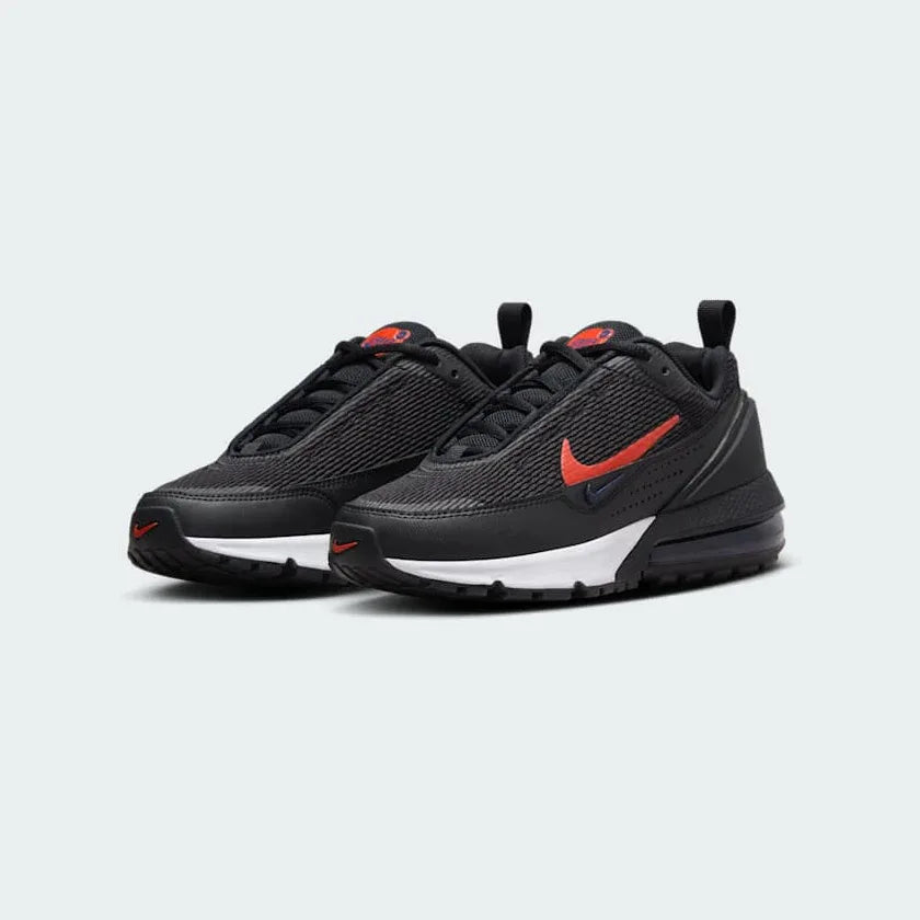 Angled view of two Nike Air Max Pulse Juniors' trainers in black and red, side by side, showcasing their bold design and visible Air unit.