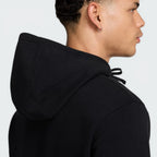 Emphasizing the contrast between the black body and the deep fir green sleeves.