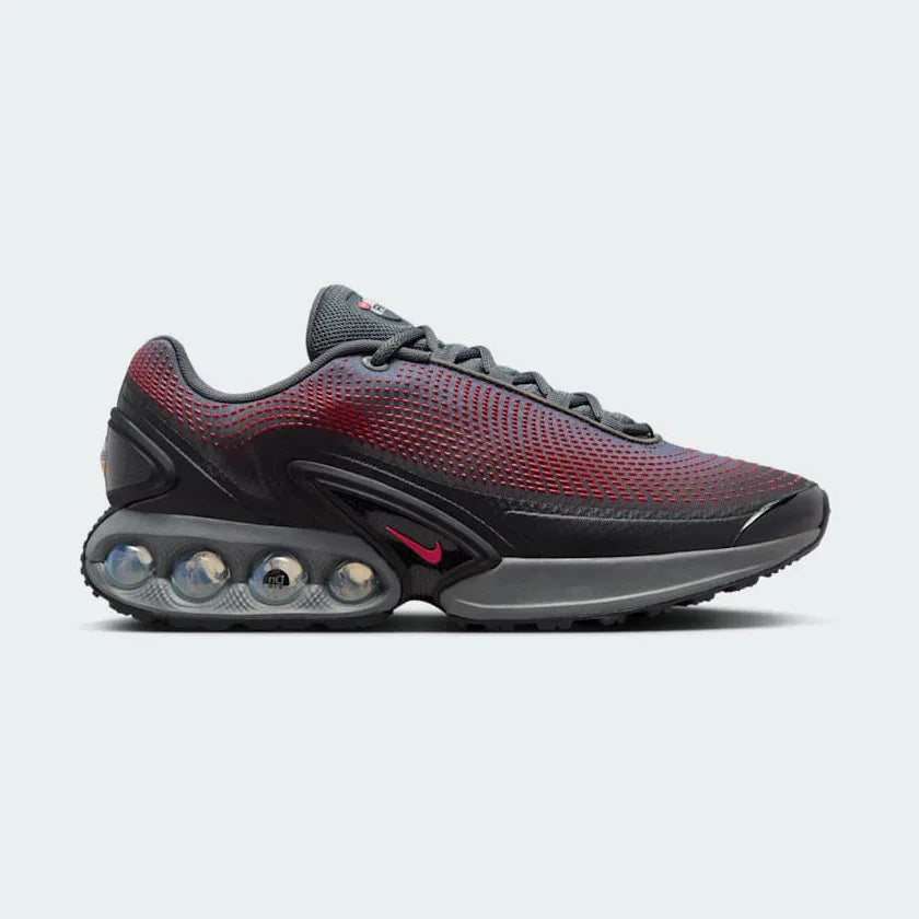 Nike Air Max DN Men's Black Trainers HM0708-002 side view showing streamlined black upper and dual-chamber Air unit in heel