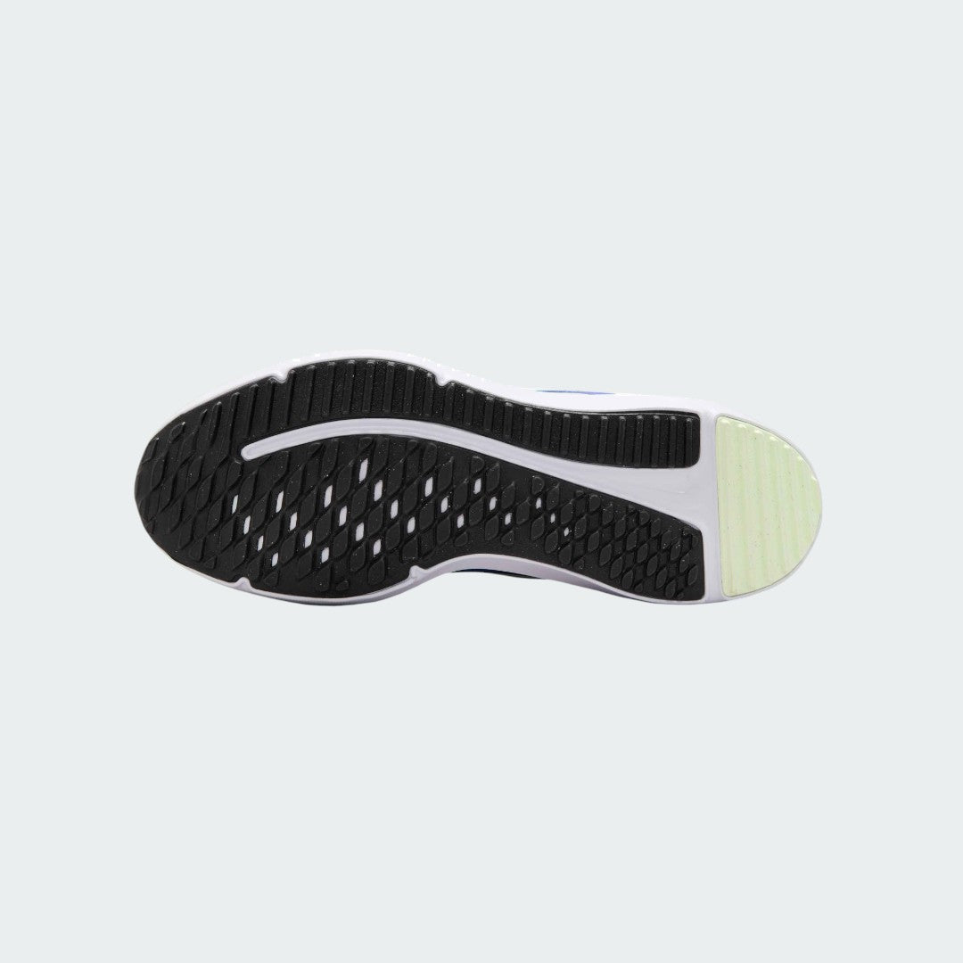 View of the outsole of the Nike Cosmic Runner Juniors' blue running trainers, showing the durable rubber tread pattern for multi-surface traction.