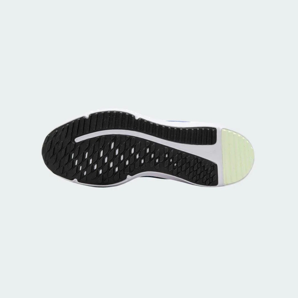 View of the outsole of the Nike Cosmic Runner Juniors' blue running trainers, showing the durable rubber tread pattern for multi-surface traction.