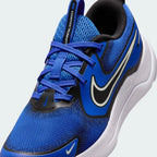 Close-up zoom on the front of the Nike Cosmic Runner Juniors' blue running trainers, showing the mesh upper texture, lacing system, and synthetic overlays.
