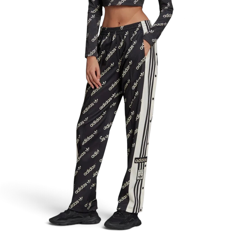 A pair of black Adidas Adibreak track pants with white stripes and monogrammed Adidas logos, featuring a drawcord on elastic waist.