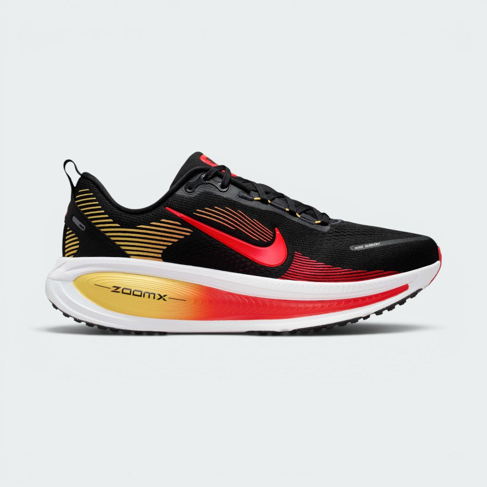 Highlights the high-velocity sweep of the contrasting crimson Nike Swoosh, showing the professional texture of the black engineered mesh upper, the topaz gold accenting, and the massive, high-walled stacked ZoomX and ReactX foam midsole base. Main image