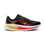 Highlights the high-velocity sweep of the contrasting crimson Nike Swoosh, showing the professional texture of the black engineered mesh upper, the topaz gold accenting, and the massive, high-walled stacked ZoomX and ReactX foam midsole base.