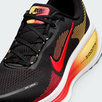 Details the premium precision of the seamless overlays reinforcing the front engineered mesh toe cap to defend against debris, alongside the neat tracking of the black and crimson laces.