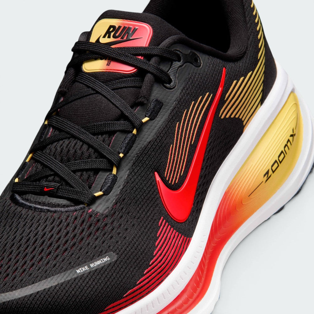 Details the premium precision of the seamless overlays reinforcing the front engineered mesh toe cap to defend against debris, alongside the neat tracking of the black and crimson laces.