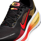 Details the premium precision of the seamless overlays reinforcing the front engineered mesh toe cap to defend against debris, alongside the neat tracking of the black and crimson laces.