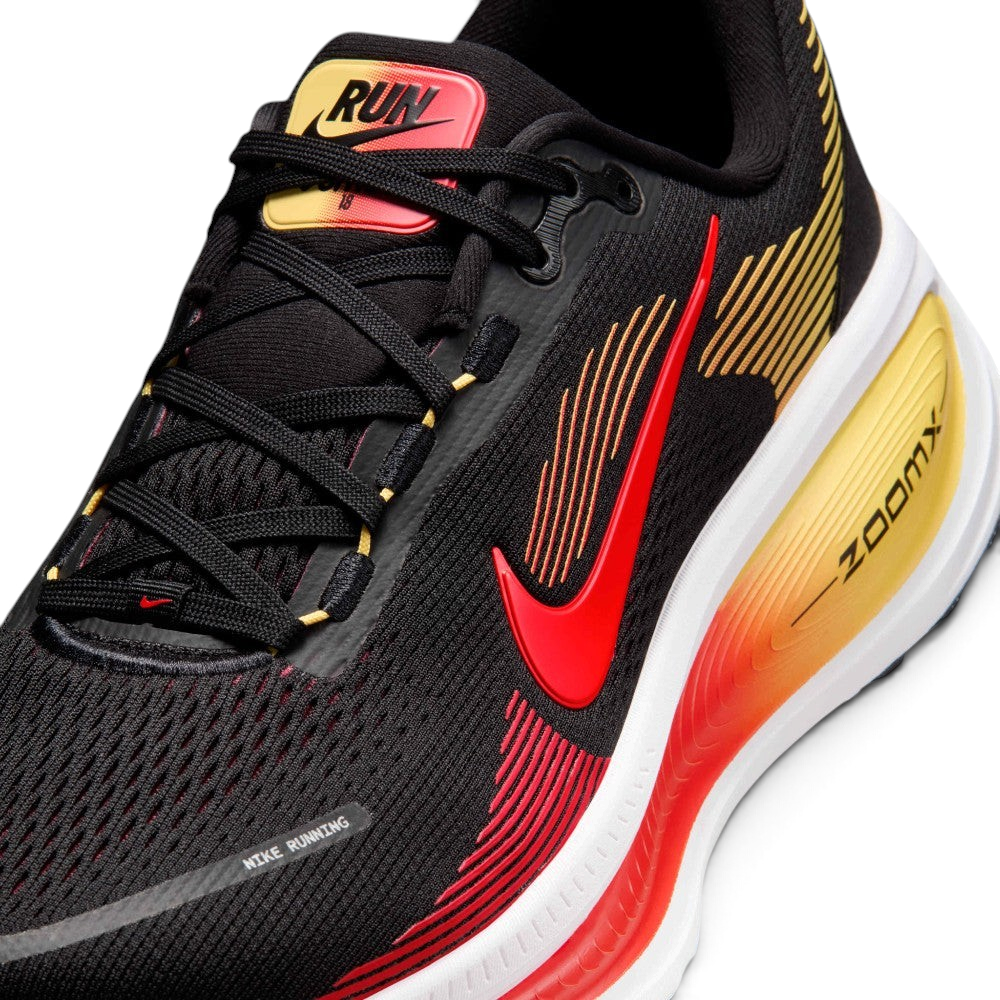 Details the premium precision of the seamless overlays reinforcing the front engineered mesh toe cap to defend against debris, alongside the neat tracking of the black and crimson laces.