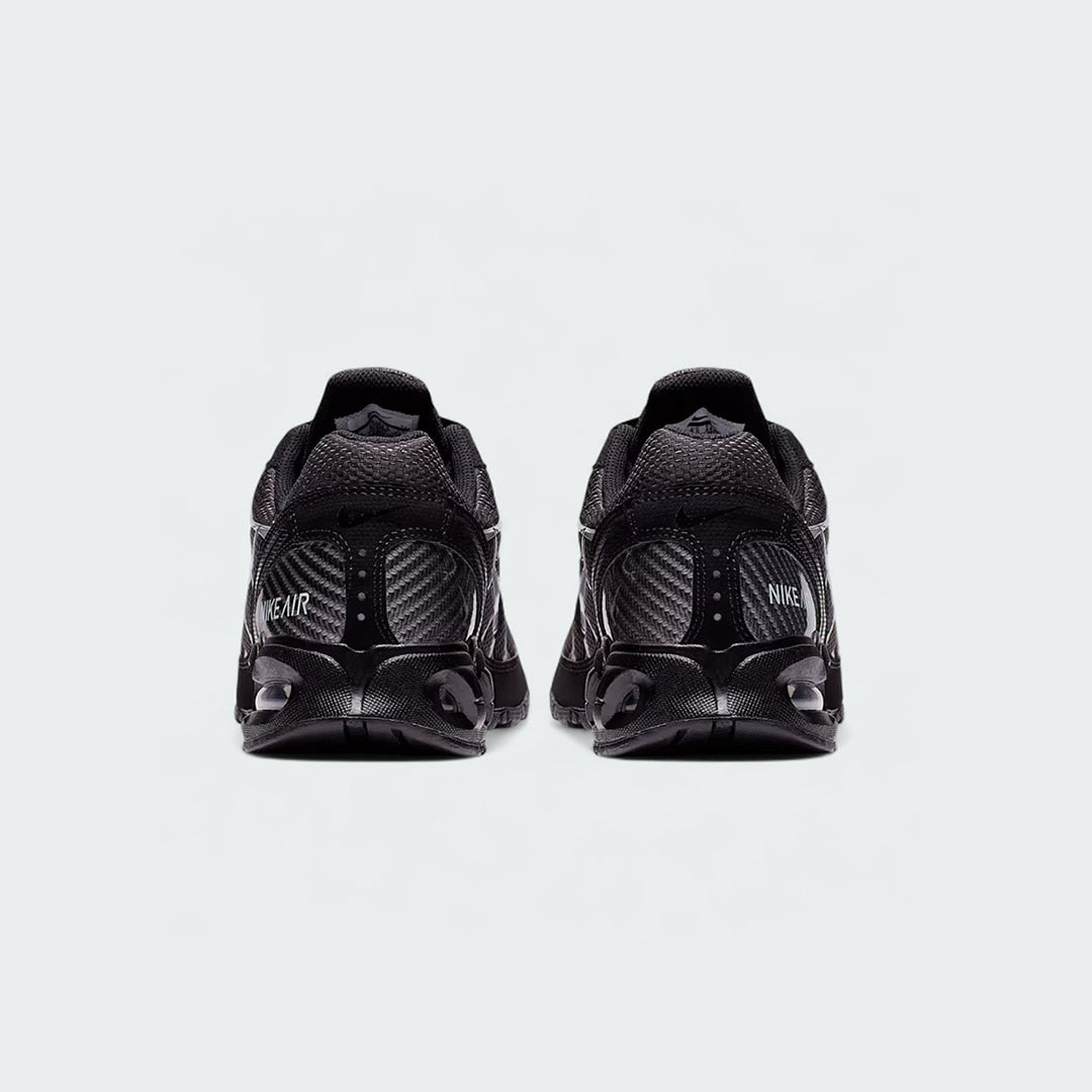 Rear view of the Nike Air Max Torch Men's black running trainers, focusing on the visible Max Air unit in the heel and subtle branding.