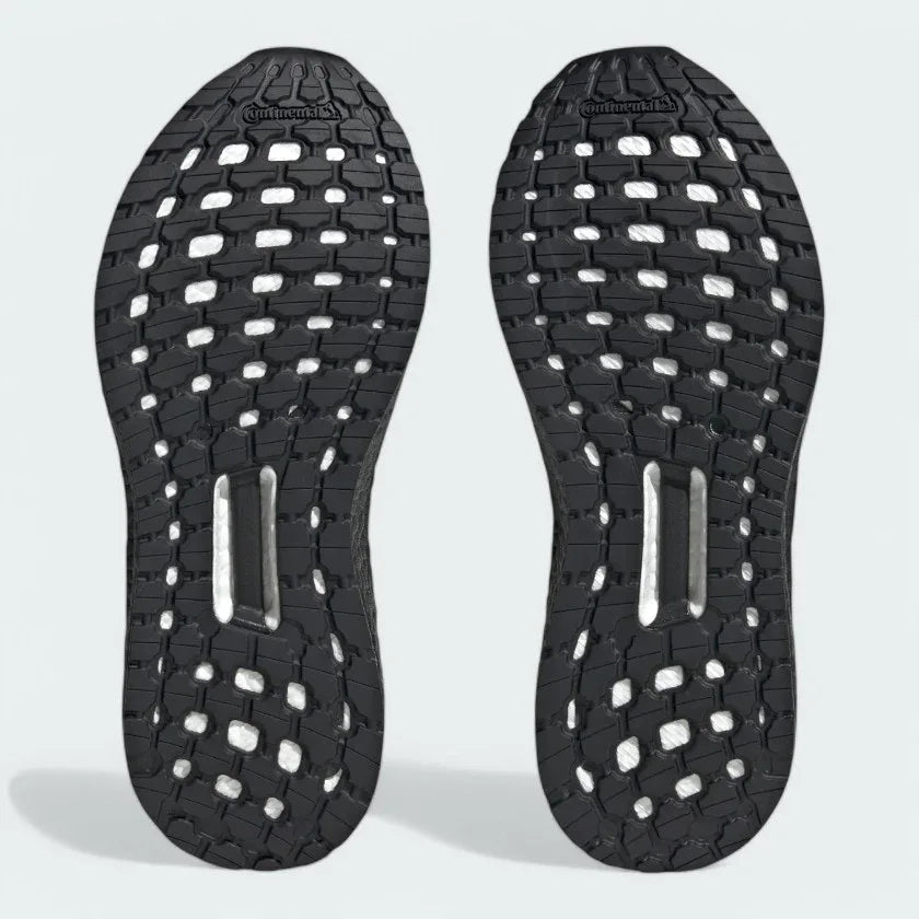 View of the outsole of the Adidas by Stella McCartney Ultra Boost 20 trainers, showing the durable rubber sole and Boost cushioning visible through the grid pattern.