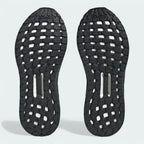 View of the outsole of the Adidas by Stella McCartney Ultra Boost 20 trainers, showing the durable rubber sole and Boost cushioning visible through the grid pattern.