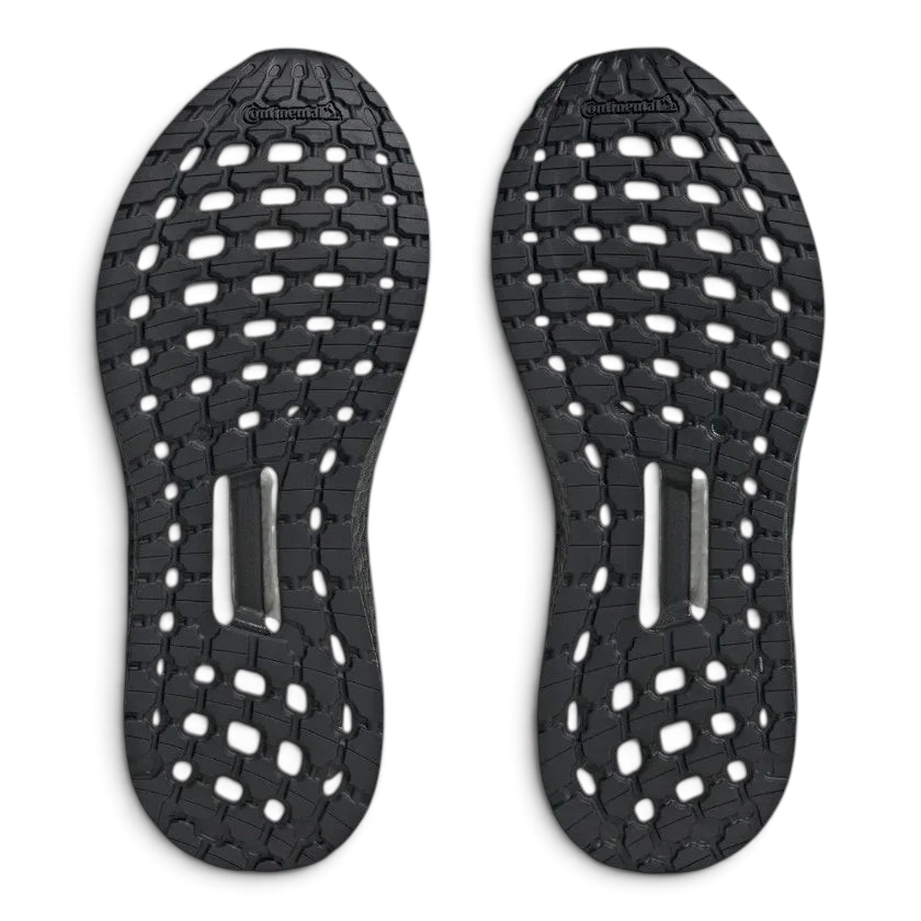 View of the outsole of the Adidas by Stella McCartney Ultra Boost 20 trainers, showing the durable rubber sole and Boost cushioning visible through the grid pattern.