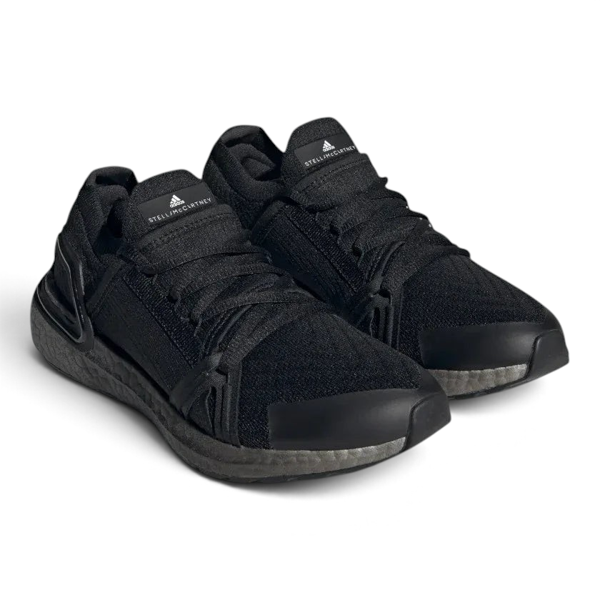 Angled view of two Adidas by Stella McCartney Ultra Boost 20 Women's trainers in black, side by side, showcasing their bold design and fashion-forward silhouette.