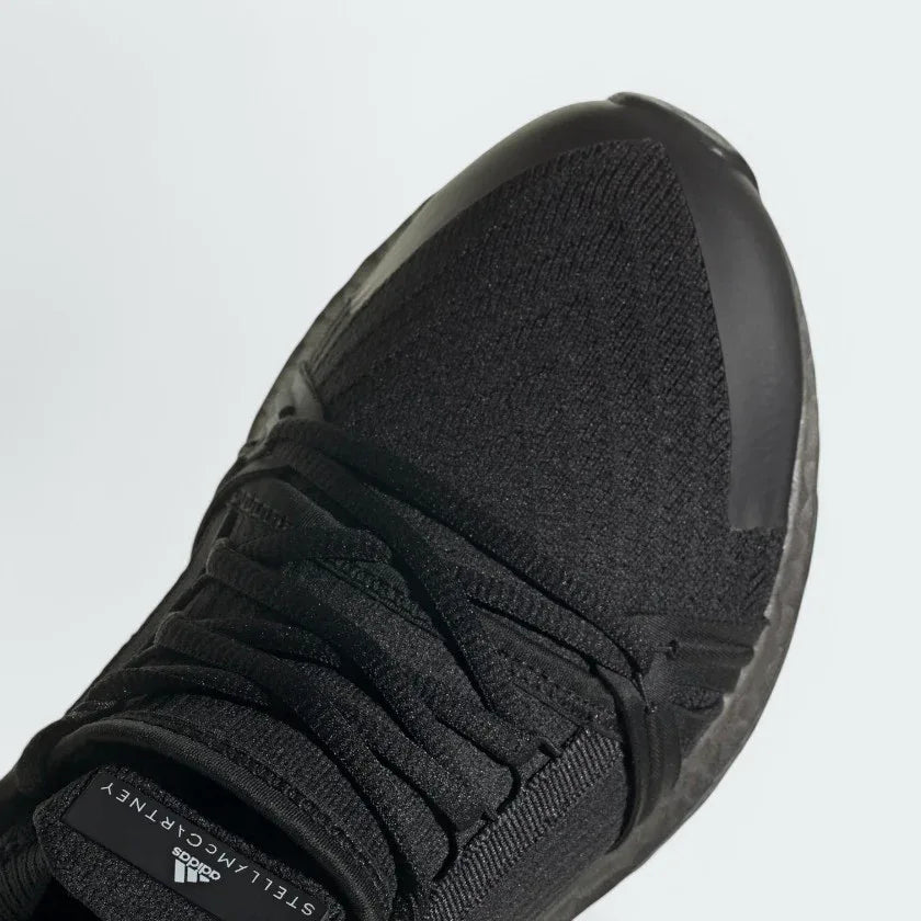 Close-up zoom on the front of the Adidas by Stella McCartney Ultra Boost 20 trainers, showing the Primeknit texture and unique lacing system.