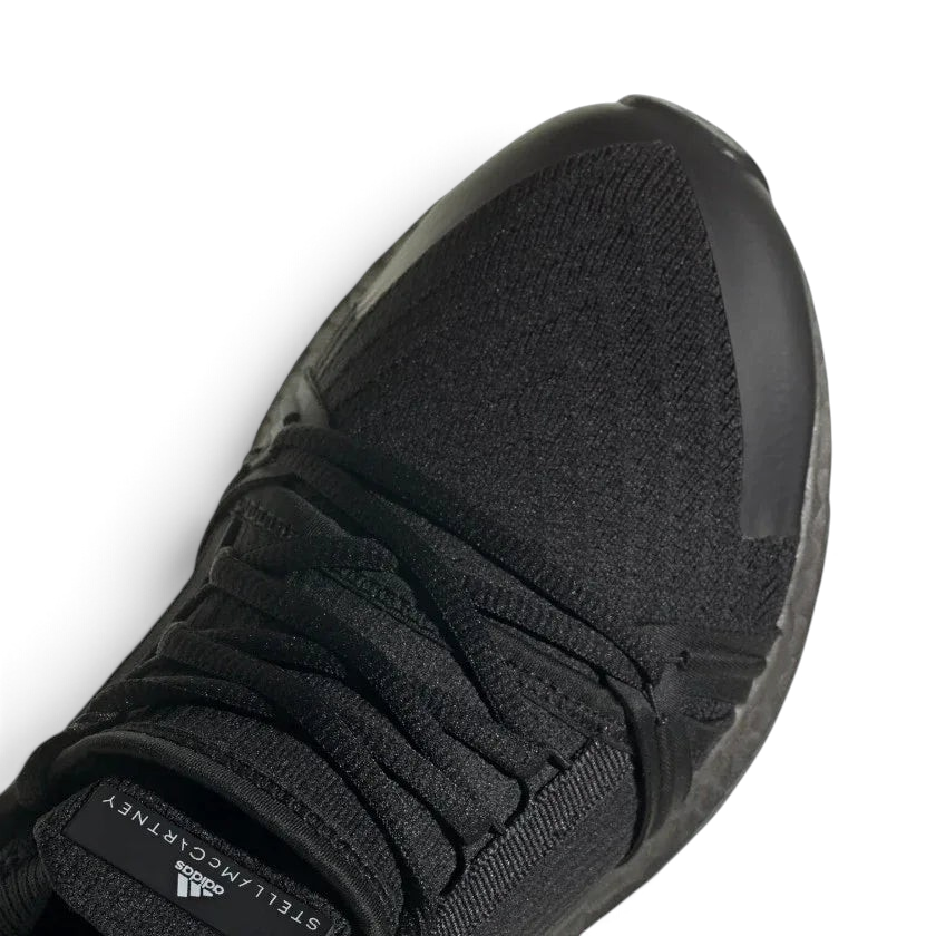 Close-up zoom on the front of the Adidas by Stella McCartney Ultra Boost 20 trainers, showing the Primeknit texture and unique lacing system.