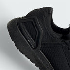 Detailed zoom on the outsole and midsole of the Adidas by Stella McCartney Ultra Boost 20 trainers, highlighting the Boost cushioning pellets and rubber tread.
