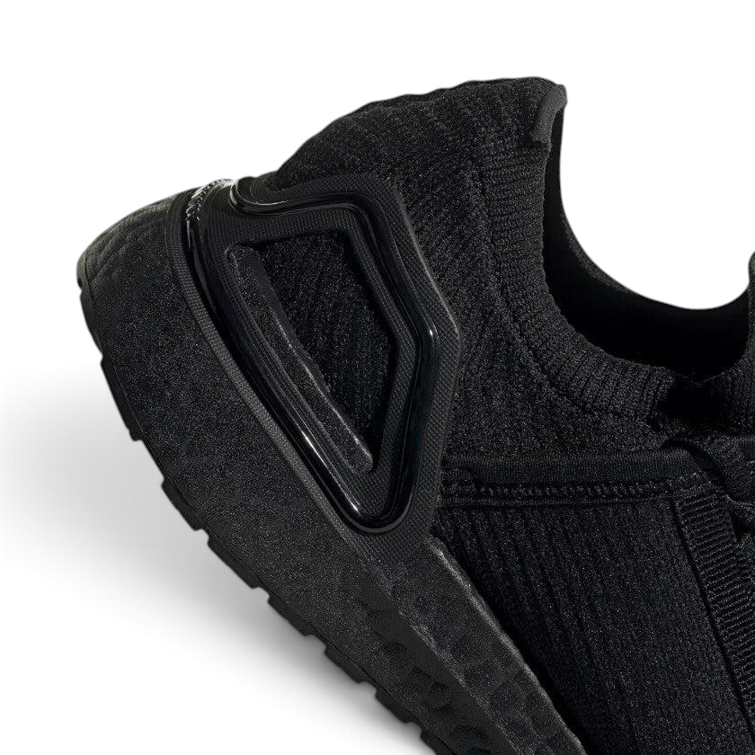 Detailed zoom on the outsole and midsole of the Adidas by Stella McCartney Ultra Boost 20 trainers, highlighting the Boost cushioning pellets and rubber tread.