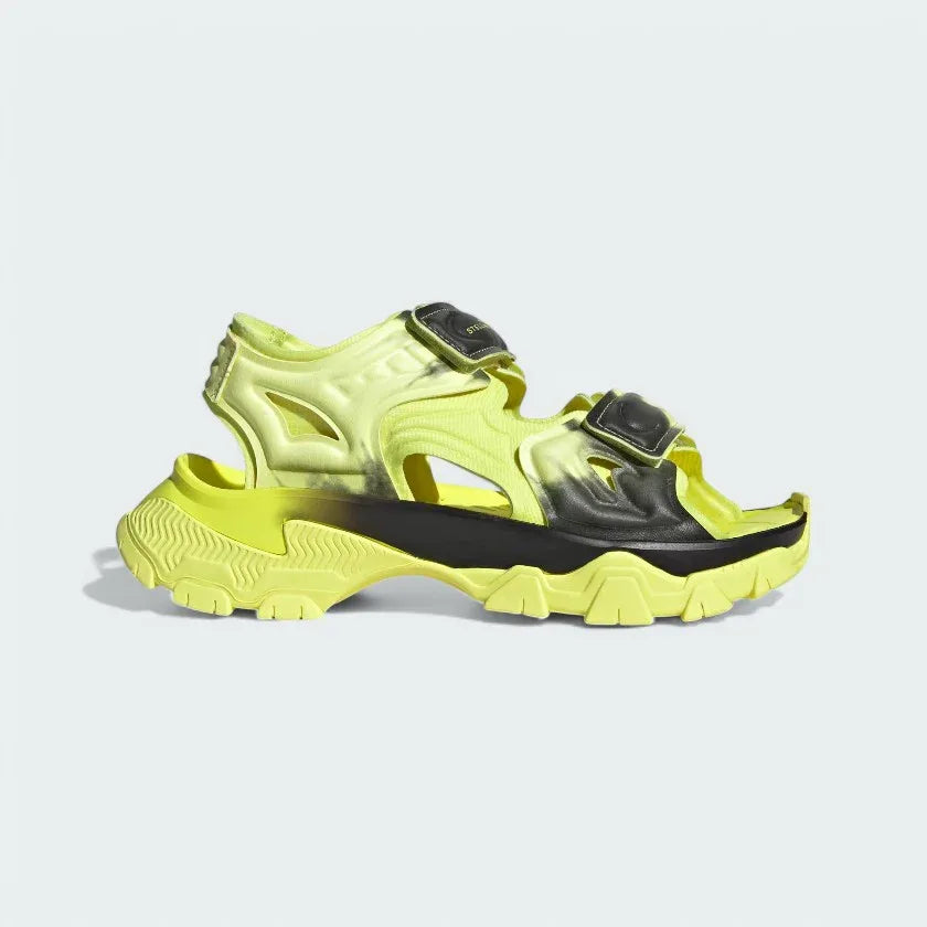 Adidas by Stella McCartney Hika Sandal in frozen yellow, side profile showing adjustable hook-and-loop straps, chunky sole, and collaborative branding. Main image