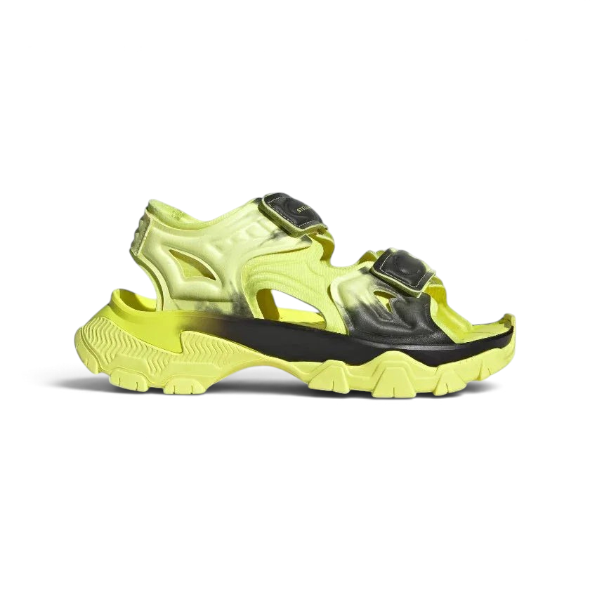 Adidas by Stella McCartney Hika Sandal in frozen yellow, side profile showing adjustable hook-and-loop straps, chunky sole, and collaborative branding. Main image
