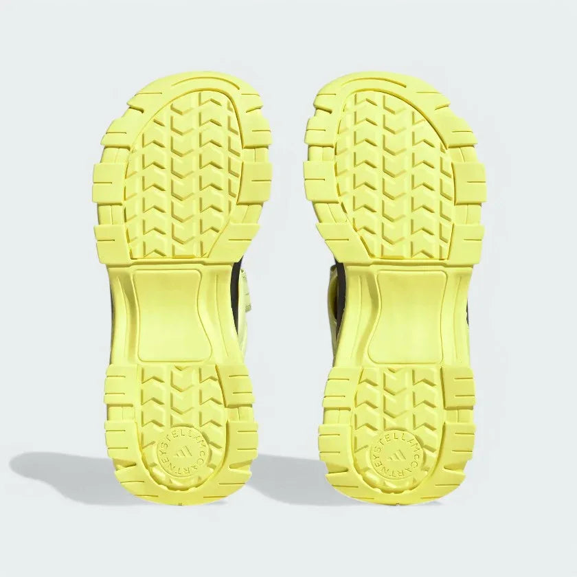 View of the outsole of the Adidas by Stella McCartney Hika Sandals in yellow, showing the durable tread pattern for grip.