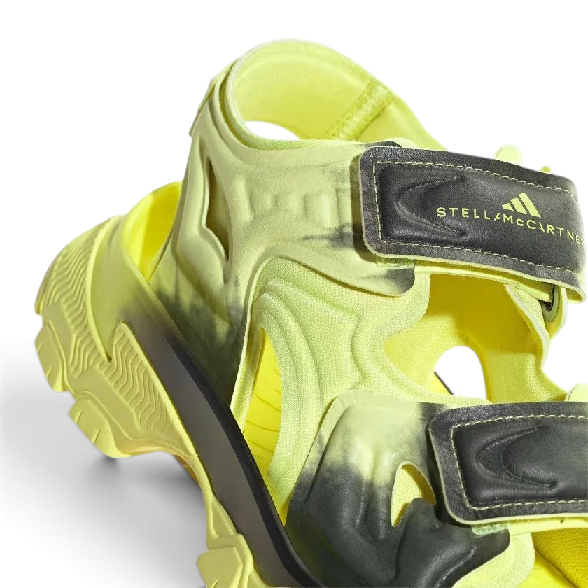 Close-up zoom on the straps of the Adidas by Stella McCartney Hika Sandal, showing the texture of the material and the collaborative Adidas by Stella McCartney logo.