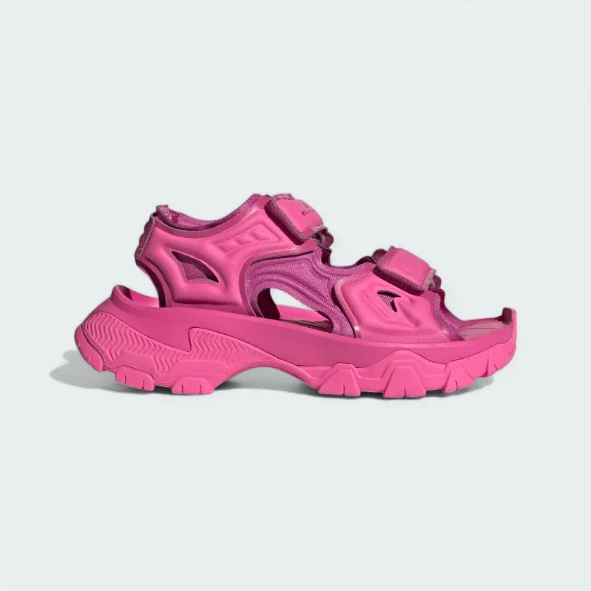 Adidas by Stella McCartney Hika Sandal in pink, side profile showing adjustable hook-and-loop straps, chunky sole, and collaborative branding. Main image