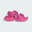 Adidas by Stella McCartney Hika Sandal in pink, side profile showing adjustable hook-and-loop straps, chunky sole, and collaborative branding.