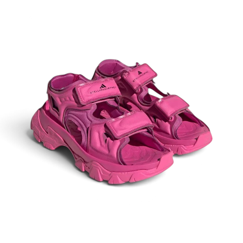 Angled view of two Adidas by Stella McCartney Hika Sandals in pink, side by side, showcasing their robust yet stylish design.